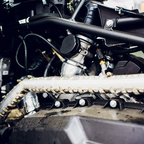 Engine compartment of ATV with overmolded parts